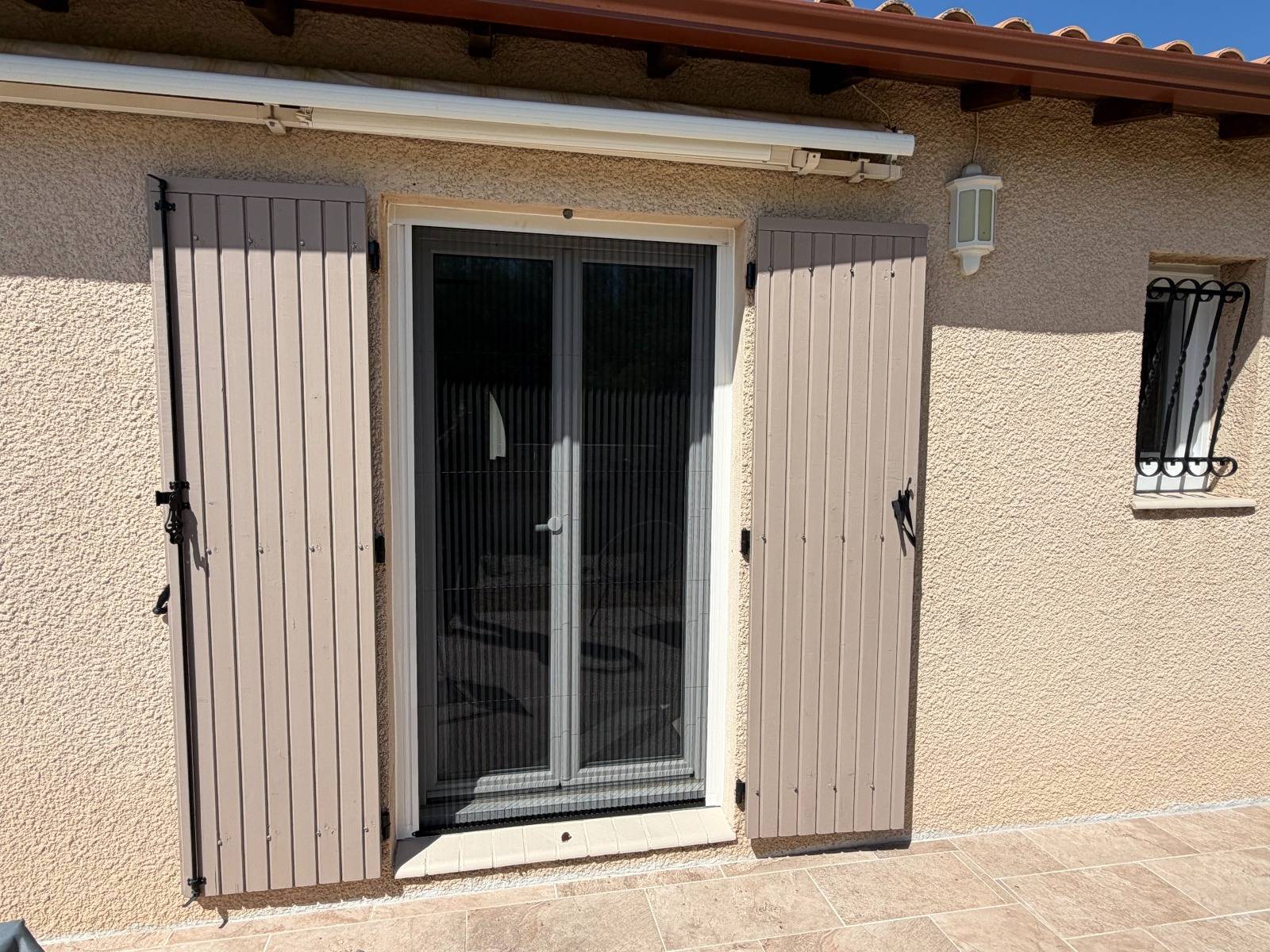 Moustiquaire porte-fenêtre sur mesure avec système enroulable et fermeture aimantée